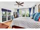Sunlit main bedroom features hardwood flooring, ceiling fan, and ample natural light through large windows at 29 Morrison Ave, McClellanville, SC 29458