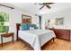 Bright bedroom with hardwood flooring, ceiling fan, and natural light, complete with a cozy, stylish aesthetic at 29 Morrison Ave, McClellanville, SC 29458