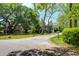 Charming street view with large trees shading the home and yard at 29 Morrison Ave, McClellanville, SC 29458