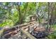 Wooden walkway winds through a lush, green forest leading to a charming wooden building at 29 Morrison Ave, McClellanville, SC 29458