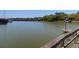 Calm waterfront featuring a wooden dock with boat docks and a serene view of the surrounding nature at 29 Morrison Ave, McClellanville, SC 29458