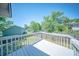A white wood deck overlooks a well-maintained lawn and a surrounding fence creating private outdoor space at 2920 Newport Pl, North Charleston, SC 29420