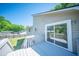 A white wood deck with steps down to the lawn and a view of the house's exterior at 2920 Newport Pl, North Charleston, SC 29420