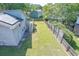 Expansive backyard with lush lawn, wooden fence, deck and solar panels on the roof at 2920 Newport Pl, North Charleston, SC 29420