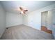 A carpeted bedroom featuring a ceiling fan, and multiple doors, offering a simple and functional space at 2920 Newport Pl, North Charleston, SC 29420