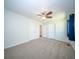 A carpeted bedroom featuring a ceiling fan, and multiple doors, offering a simple and functional space at 2920 Newport Pl, North Charleston, SC 29420