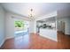 Dining room with hardwood floors, sliding glass door to deck, open to updated kitchen at 2920 Newport Pl, North Charleston, SC 29420