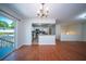 Bright, open-concept living area with hardwood floors, stainless steel kitchen, and sliding glass door to deck at 2920 Newport Pl, North Charleston, SC 29420