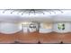 Spacious living area with hardwood flooring, white walls, lots of natural light, and a view of the updated kitchen at 2920 Newport Pl, North Charleston, SC 29420