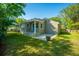 Charming backyard with a well-maintained lawn, patio, and classic brick home at 3 Lord Ashley Dr, Charleston, SC 29407