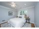 Comfortable bedroom with a cozy bed, neutral decor, ceiling fan, and abundant natural light at 3 Lord Ashley Dr, Charleston, SC 29407