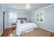 Cozy bedroom with a plush bed, neutral tones, wood floors, a ceiling fan, and natural light at 3 Lord Ashley Dr, Charleston, SC 29407