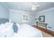 Serene bedroom featuring a comfortable bed, white bedding, wood floors, and a decorative console table at 3 Lord Ashley Dr, Charleston, SC 29407