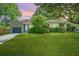 Charming brick home with a lush green lawn, mature trees, and a single-car garage at 3 Lord Ashley Dr, Charleston, SC 29407