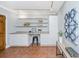 Bright home office featuring built-in shelves, cabinets, desk, and stylish decor and track lighting at 3 Lord Ashley Dr, Charleston, SC 29407