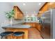 Galley kitchen with breakfast bar, stainless steel appliances, warm-toned cabinets, and tile flooring at 3 Lord Ashley Dr, Charleston, SC 29407