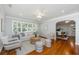 Living room with large windows, neutral decor, and open access to dining area at 3 Lord Ashley Dr, Charleston, SC 29407