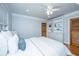 Cozy main bedroom features a ceiling fan, hardwood floors, and built-in shelves for ample storage space at 3 Lord Ashley Dr, Charleston, SC 29407