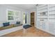 Inviting mud room provides seating, storage, and easy outdoor access through a glass paneled door at 3 Lord Ashley Dr, Charleston, SC 29407