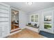 Cozy mud room features storage, a bench, and natural light, perfect for entry or relaxation at 3 Lord Ashley Dr, Charleston, SC 29407