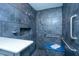 Modern shower room with dark tiling, a built-in niche, a shower seat, and accessibility bars at 3 Lord Ashley Dr, Charleston, SC 29407