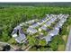 A high aerial showcases the layout of this neighborhood with its organized streets and beautiful surrounding forest at 344 Flyway Rd, Goose Creek, SC 29445