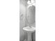 Well-lit bathroom with a pedestal sink, rounded mirror, and contemporary fixtures at 344 Flyway Rd, Goose Creek, SC 29445