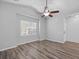 Bright bedroom features wood-look flooring, ceiling fan, window with blinds, and neutral paint at 344 Flyway Rd, Goose Creek, SC 29445