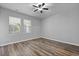 Comfortable bedroom with wood floors, two windows, and a neutral color palette at 344 Flyway Rd, Goose Creek, SC 29445