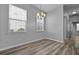 Charming dining area with hardwood floors, two windows for great natural light, and modern chandelier at 344 Flyway Rd, Goose Creek, SC 29445