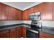 Kitchen featuring stainless steel appliances, dark countertops and wood cabinets at 344 Flyway Rd, Goose Creek, SC 29445