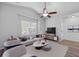 Living room with stylish furniture, wood-look flooring, ceiling fan, and natural light at 344 Flyway Rd, Goose Creek, SC 29445