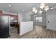 Open kitchen and living space with wood-look floors, stylish pendant, and modern finishes at 344 Flyway Rd, Goose Creek, SC 29445