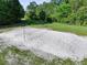 Aerial view of a sand volleyball court in a green, tree-lined common area at 344 Flyway Rd, Goose Creek, SC 29445