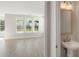 Stylish bathroom with a modern sink, vanity, and views of the sunny open concept main living area at 354 Claret Cup Way, Charleston, SC 29414