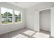 Sunlit bedroom boasting neutral carpet, a spacious closet, and large windows for abundant natural light at 354 Claret Cup Way, Charleston, SC 29414