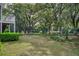 Lush green backyard featuring mature trees and well-manicured landscaping, perfect for relaxing and outdoor activities at 3567 Somerset Hills Ct, Mount Pleasant, SC 29466