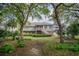 Backyard view of the home with a deck and lush, mature landscaping at 3567 Somerset Hills Ct, Mount Pleasant, SC 29466