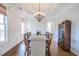 Formal dining room featuring hardwood floors, detailed trim work, and a modern chandelier at 3567 Somerset Hills Ct, Mount Pleasant, SC 29466