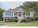 Charming two story home featuring gray siding, brick accents, an inviting front porch and mature landscaping at 3567 Somerset Hills Ct, Mount Pleasant, SC 29466