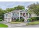 Inviting home featuring a charming porch with columns, a double staircase, and professional landscaping at 3567 Somerset Hills Ct, Mount Pleasant, SC 29466