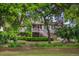 Charming two-story home with a well-manicured lawn and mature trees, offering a serene and inviting curb appeal at 3567 Somerset Hills Ct, Mount Pleasant, SC 29466