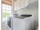 Bright laundry room with a pair of modern, front-loading washers and dryers at 3567 Somerset Hills Ct, Mount Pleasant, SC 29466