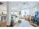 Open living room featuring hardwood floors, wicker furniture, and large windows at 3567 Somerset Hills Ct, Mount Pleasant, SC 29466