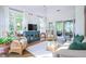 Bright living room with hardwood floors, wicker furniture, and vaulted ceiling at 3567 Somerset Hills Ct, Mount Pleasant, SC 29466