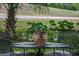 Outdoor table set with wine glasses and decor, perfect for enjoying alfresco dining in a lush, scenic setting at 3567 Somerset Hills Ct, Mount Pleasant, SC 29466