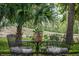 Outdoor table set with wine glasses and decor, perfect for enjoying alfresco dining in a lush, scenic setting at 3567 Somerset Hills Ct, Mount Pleasant, SC 29466