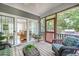 Screened-in porch with wicker furniture and view to the backyard at 3567 Somerset Hills Ct, Mount Pleasant, SC 29466