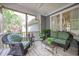 Comfortable screened-in porch with wicker furniture and relaxing outdoor view at 3567 Somerset Hills Ct, Mount Pleasant, SC 29466