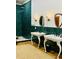 Bathroom featuring double sinks, green tiled shower, wooden floors and modern fixtures at 41 Pitt St, Charleston, SC 29401